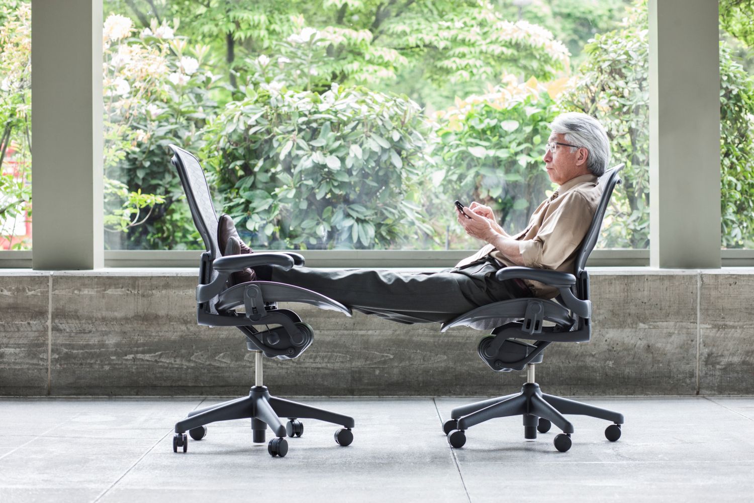 man relaxing on office chairs